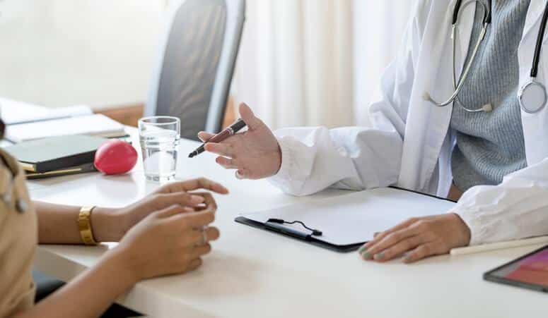 A clinical researcher interviewing a member of a research subgroup after clinical research training