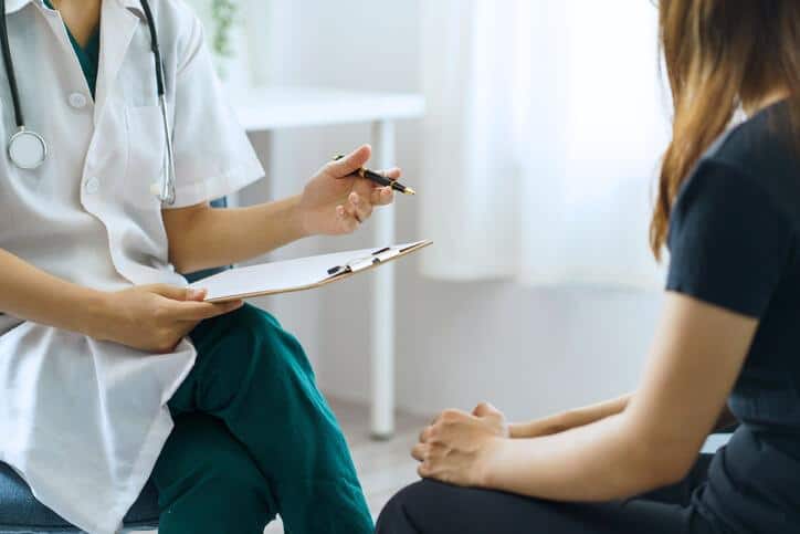 A clinical researcher interacting with a member of her population after clinical research training