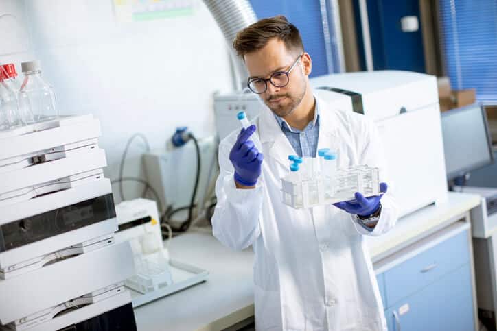 An analytical chemist working with an HPLC system after earning an HPLC certificate.