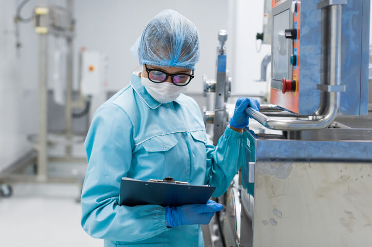 Female quality assurance professional examining a notepad during food safety training