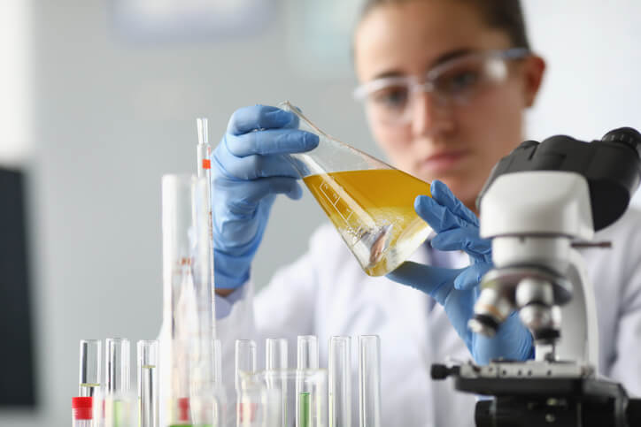 A female clinical research professional examining a chemical during clinical research training