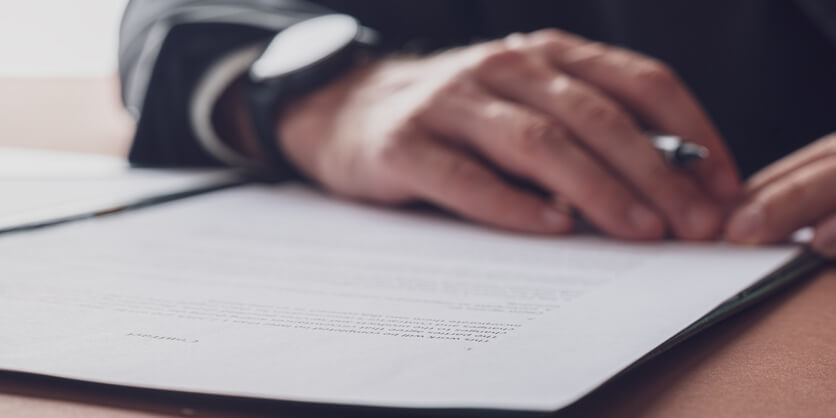 Male reviewing a document after his regulatory affairs program