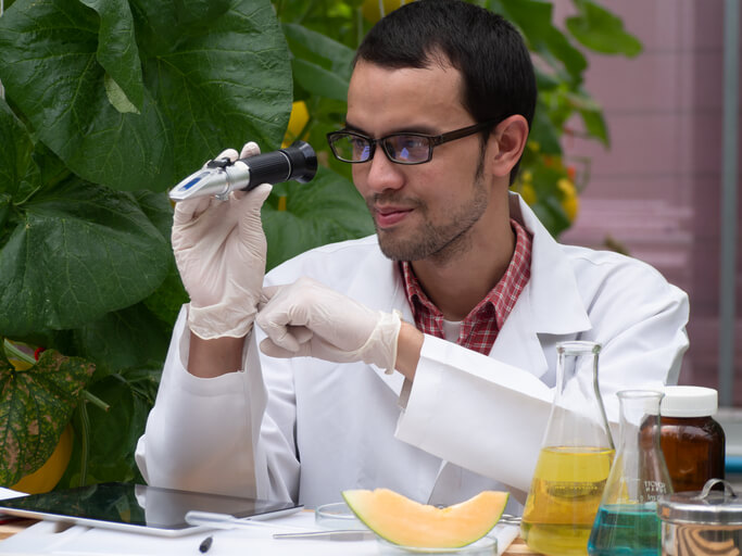 A male product development technologist testing an organic bioproduct in a laboratory after completing his food safety training
