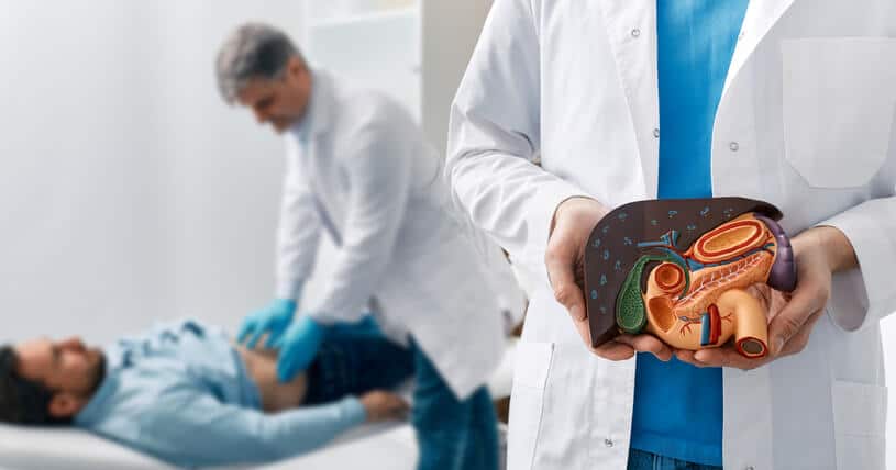 A doctor examining a patient for liver damage from the use of cannabis products as seen in cannabis industry training.