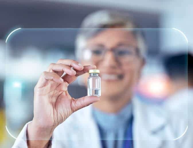 A Clinical Research Coordinator holding a drug sample in a lab after clinical research training