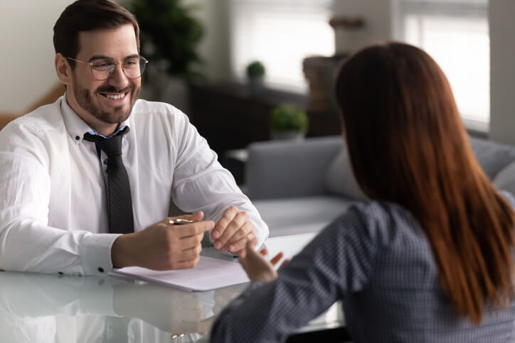 A male clinical research professional being interviewed by a female employer