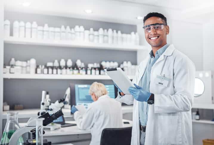 A smiling male pharmaceutical professional in a laboratory after pharmaceutical training