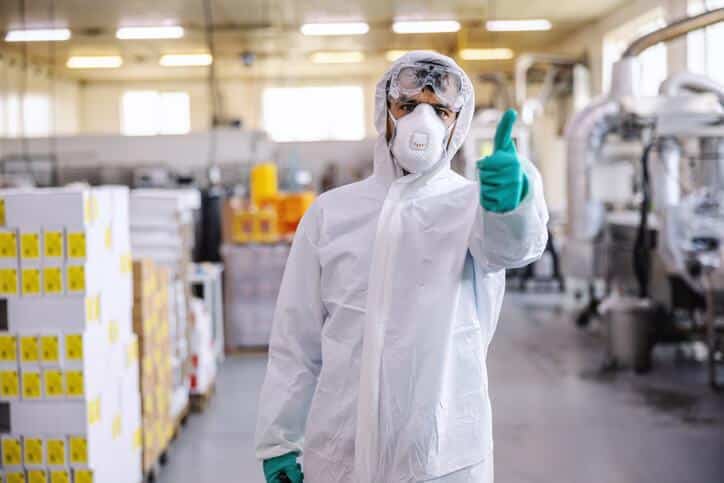 A food safety professional giving the thumbs up in a food production factory after food safety training