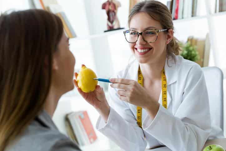 A smiling female health consultant consulting with a patient after nutrition, health, and sports training.
