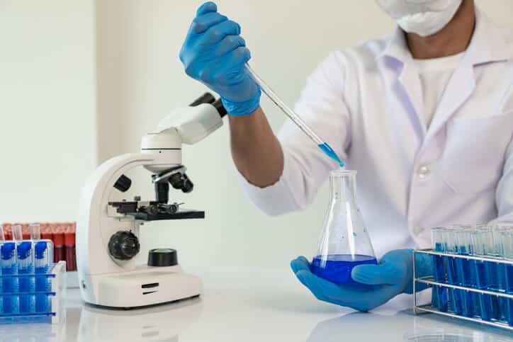 Female quality assurance professional working in a laboratory after pharmaceutical training