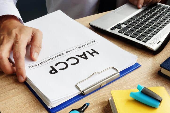 A food safety professional studying HACCP requirements after food safety training