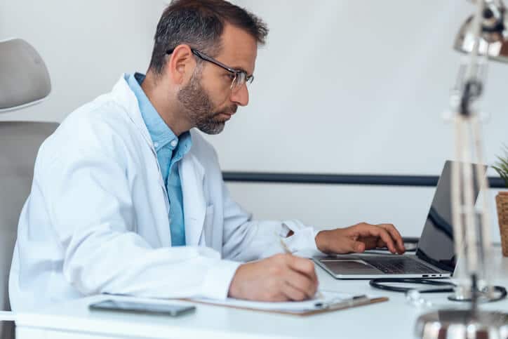 A male clinical research professional attending an online pharmaceutical training course
