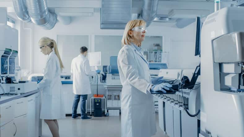 Three pharmaceutical professionals in a lab after pharmaceutical training