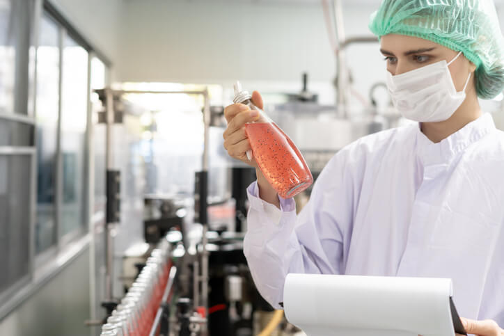 A male quality assurance professional inspecting a product using USP guidelines