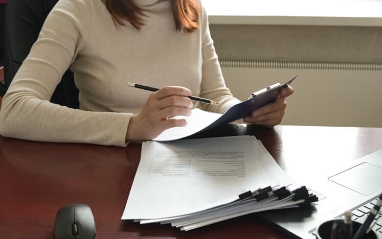 A female RA associate working with various submission documents after completing her regulatory affairs training