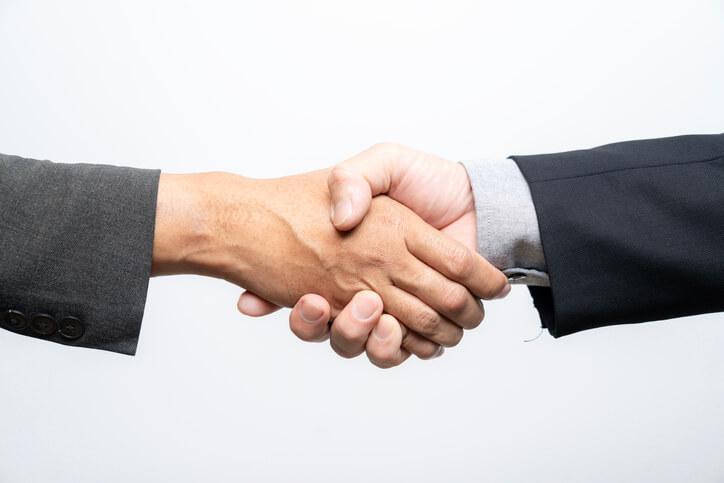 A student shaking hands with a member of the AAPS Career Services team during pharmaceutical training 